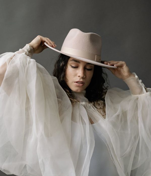Woman in a dynamic, flowing cardio pose in a studio with soft lighting.